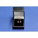 A pair of 9ct gold ruby and diamond floral pendant earrings, 2g in total.