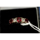 An 18ct gold ring set three rubies and two diamonds.