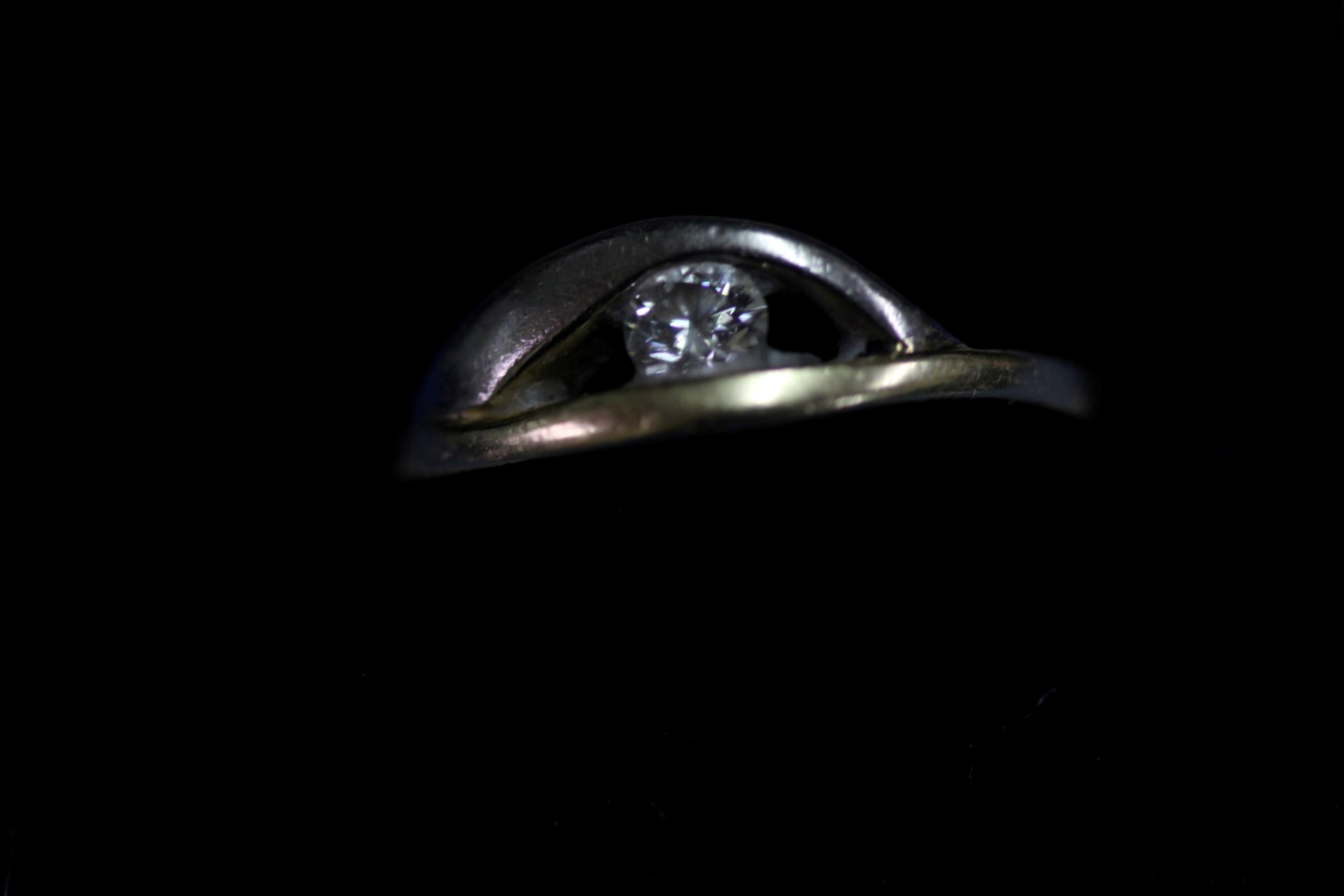 An unmarked yellow and white metal ring set single diamond. - Image 2 of 3