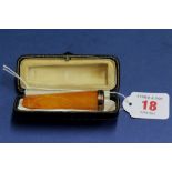 A 9ct gold mounted amber cheroot holder in fitted case, 12.2g in total.