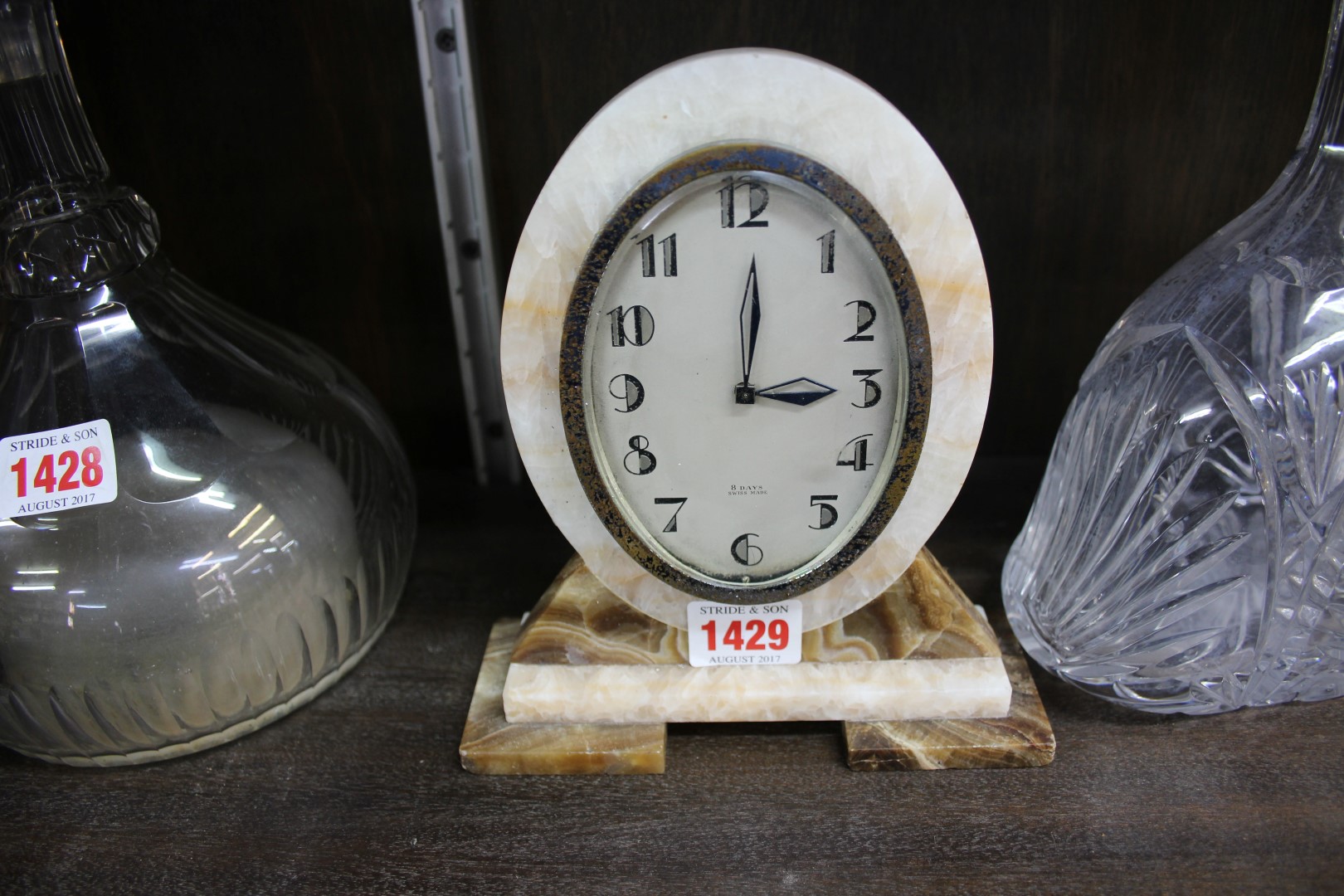An Art Deco onyx timepiece, 18cm high.