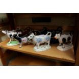 Eight various cow creamers, (one lacking cover).