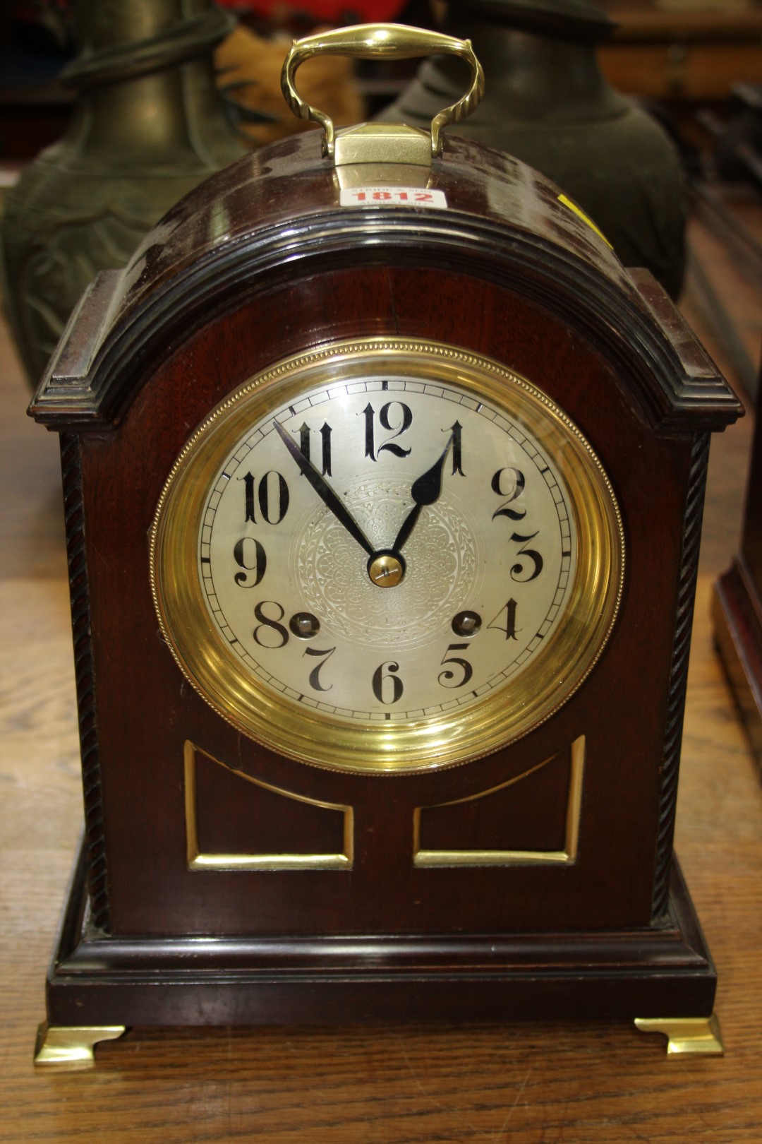 An 18th century style mahogany dome top mantel clock, height including handle 32.5cm.