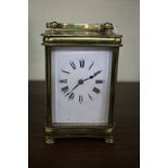 An antique brass carriage clock, striking on a gong, height including handle 15.5cm.