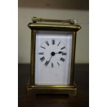 An old brass carriage timepiece, height including handle, 15cm.