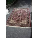 A machine made rug, with all over floral design and central medallion, 202 x 140cm.