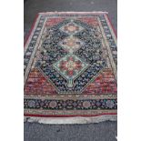 A Southern Persian design carpet, with three medallions and geometric motifs with birds in field,