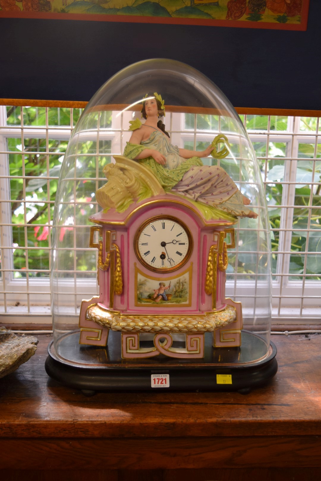 A late 19th century Continental porcelain mantel clock, with figural surmount,