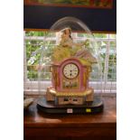 A late 19th century Continental porcelain mantel clock, with figural surmount,