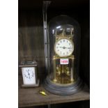 A brass anniversary clock, with glass dome; together with an old brass carriage timepiece,