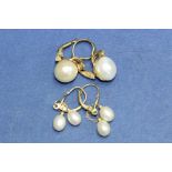 A pair of 9ct gold double pearl pendants earrings; together with another pair set in silver.