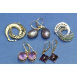 Three pairs of 9k gold earrings; two set with amethysts; one set large teardrop grey pearls;