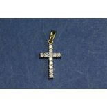 An 18ct gold diamond set cross.