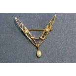 A 9ct gold brooch set three opals.