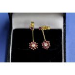 A pair of 9ct gold ruby and diamond floral pendant earrings, 2g total.