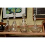 Four antique clear glass decanters and stoppers.