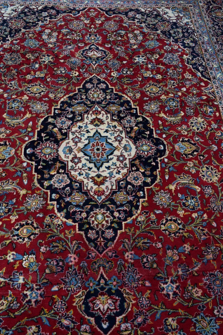 A Persian 'Kashan' carpet, with large coastal medallion on a floral red field, 352 x 251 cm. - Image 3 of 10