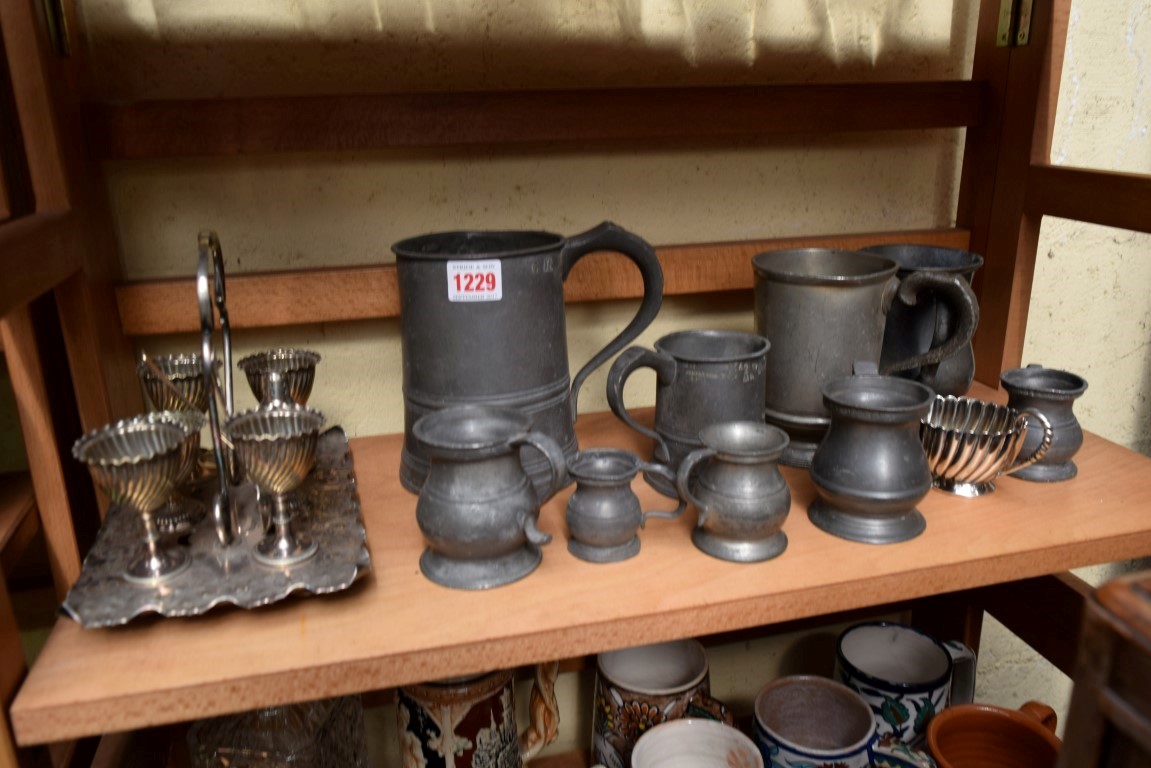 A collection of pewter baluster measures; together with an electroplated egg cruet; etc.