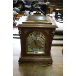 A late 19th century oak and cast brass mounted mantel clock, striking on two gongs, 42cm high.