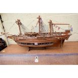 A wooden model of a galleon, the hull 70cm long.