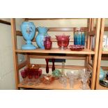 A mixed lot of clear and coloured glass, (2 shelves).