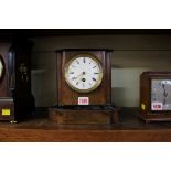 A late 19th century walnut and ebonized mantel timepiece, 22.5cm high.