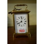 An old brass carriage timepiece, height including handle, 14cm with winding key.