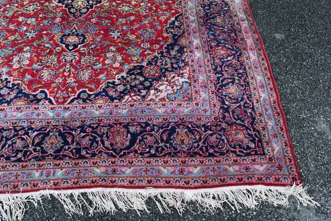 A Persian 'Kashan' carpet, with large coastal medallion on a floral red field, 352 x 251 cm. - Image 8 of 10