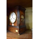 A late 19th century rosewood mantel clock, with brass lion mask side handles, 28cm high.