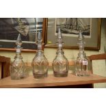 Four Victorian clear glass decanters and stoppers.