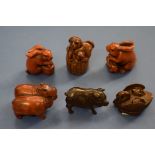 A collection of six Japanese carved wood netsukes,