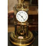 A brass anniversary timepiece, with glass dome, 29cm high.