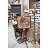 An antique mahogany tripod pole screen, with needlework panel.