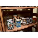 Seven Iznik and Jerusalem mugs; together with a stein; and a clear glass decanter and stopper.