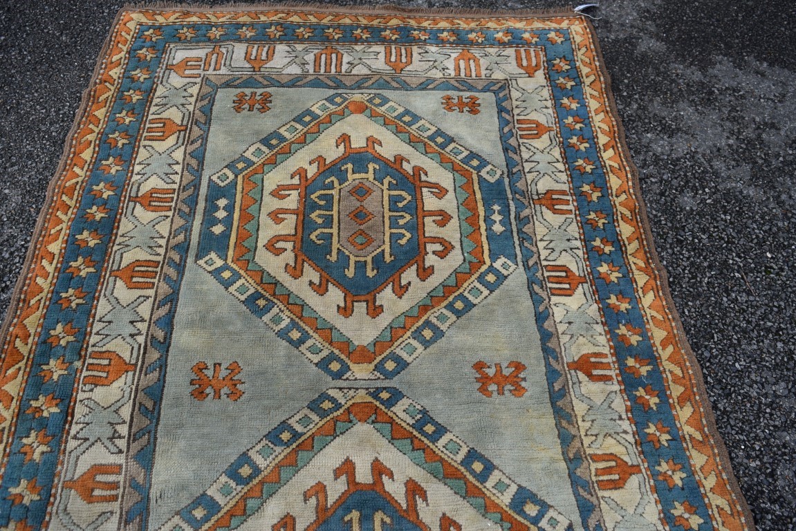 A Turkish Kars rug, with two large repeated geometric medallions and geometric design borders, - Image 3 of 8