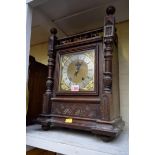 A late 19th century/early 20th century carved oak mantel clock, 48cm high.