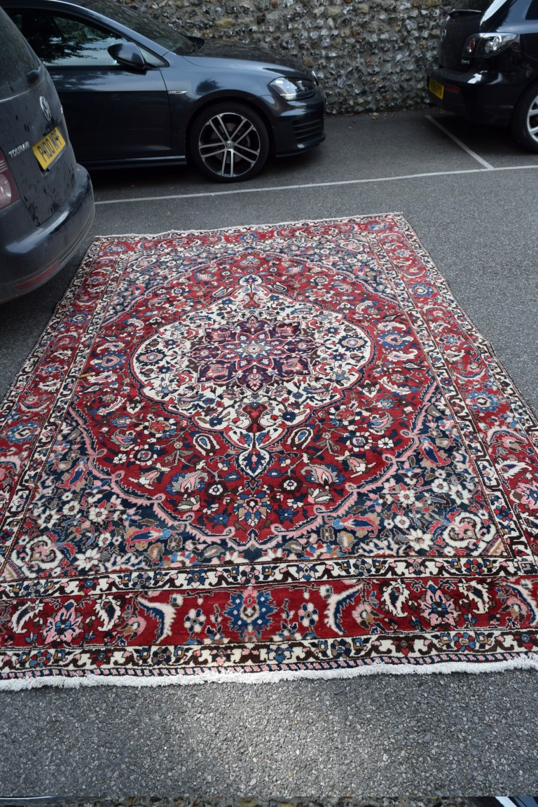 A Persian 'Bakhtiari' carpet, with large central floral medallion on a red floral field, - Image 4 of 8