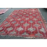 A large Turkish flat weave kelim carpet, with an all over geometric lattice design on a red field,