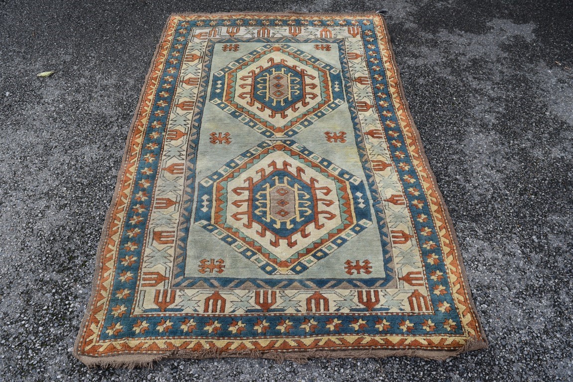 A Turkish Kars rug, with two large repeated geometric medallions and geometric design borders,