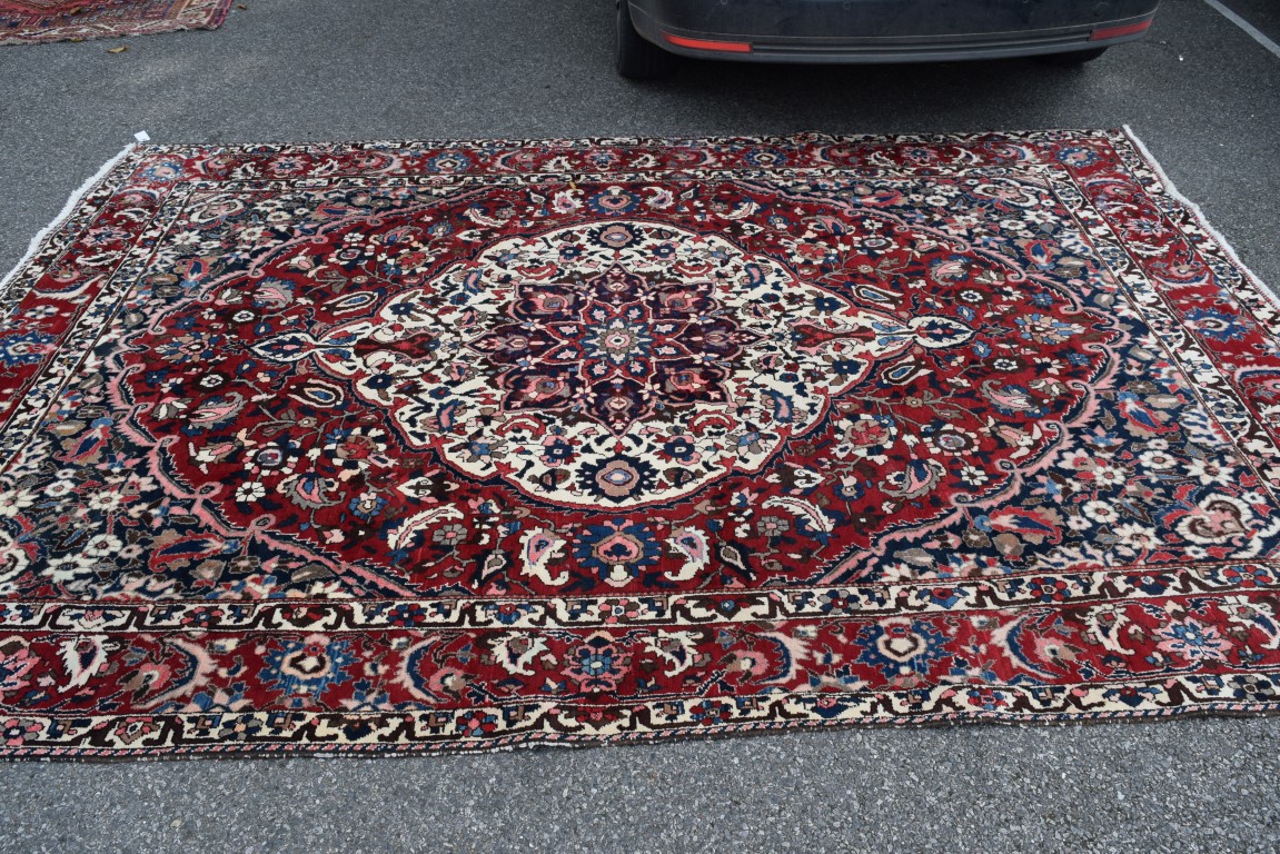 A Persian 'Bakhtiari' carpet, with large central floral medallion on a red floral field, - Image 2 of 8