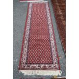 A narrow machine made runner, of Persian Hamadan design,