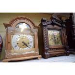 An antique walnut mantel clock; together with a reproduction oak example.