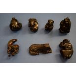 A collection of seven Japanese carved wood netsukes,