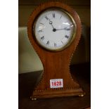 An Edwardian mahogany and chequer strung balloon timepiece, 22.5cm high.