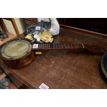A small beechwood four string banjolele, 51cm long.