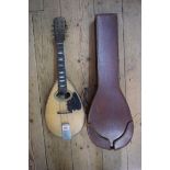 A flatback mandolin, labelled and inscribed 'John E Dallas', and numbered 4733, in tan leather case.