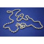 A two strand pearl necklace having unmarked metal clasp, 50cm.