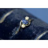 An 18ct gold sapphire and diamond three stone ring.