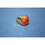 An unmarked signet ring set oval carved coral bust of lady.