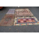 A collection of three flatweave rugs; together with a North West Persian rug with dated cartouche.